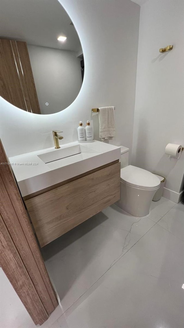 bathroom featuring vanity and toilet