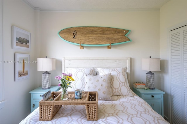 bedroom with a closet and ornamental molding