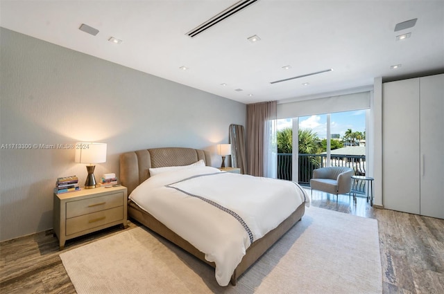 bedroom featuring access to exterior and wood-type flooring