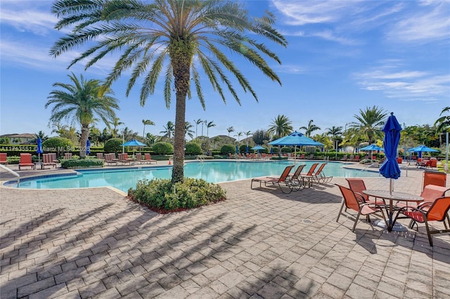 pool featuring fence and a patio