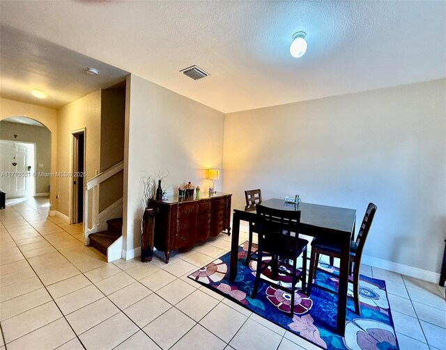 living room with ceiling fan and light tile patterned floors