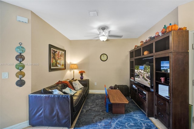 living room with ceiling fan and baseboards