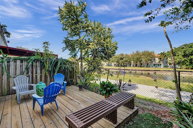 wooden terrace featuring fence