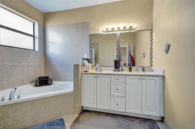 bathroom with double vanity, a sink, and a bath