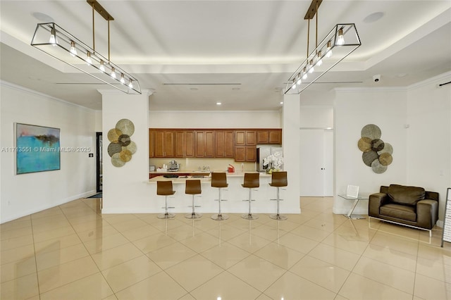 kitchen featuring pendant lighting, a kitchen bar, light countertops, open floor plan, and stainless steel fridge with ice dispenser