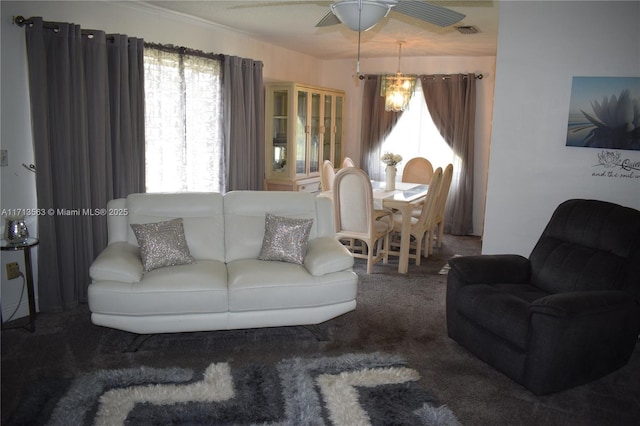 living room featuring carpet and ceiling fan