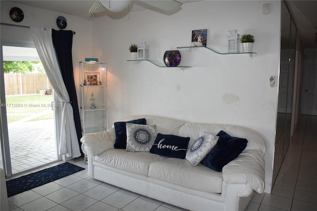 tiled living room with ceiling fan