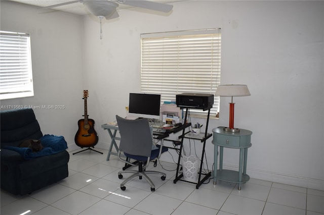 office area with light tile patterned floors and ceiling fan