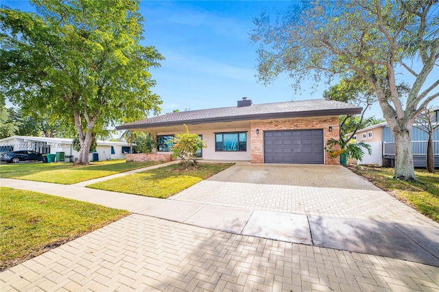 view of front of house with a front yard and a garage