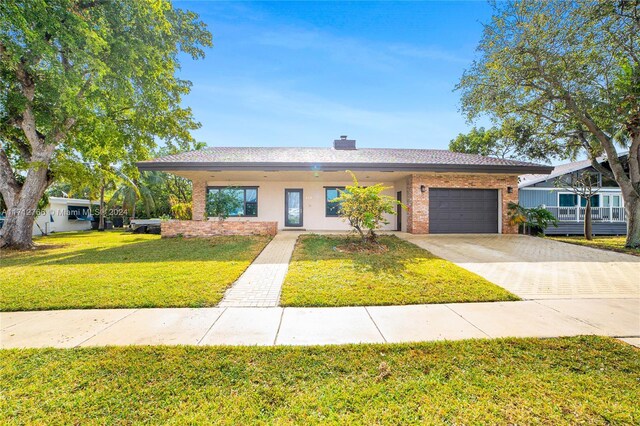 single story home featuring a front yard and a garage