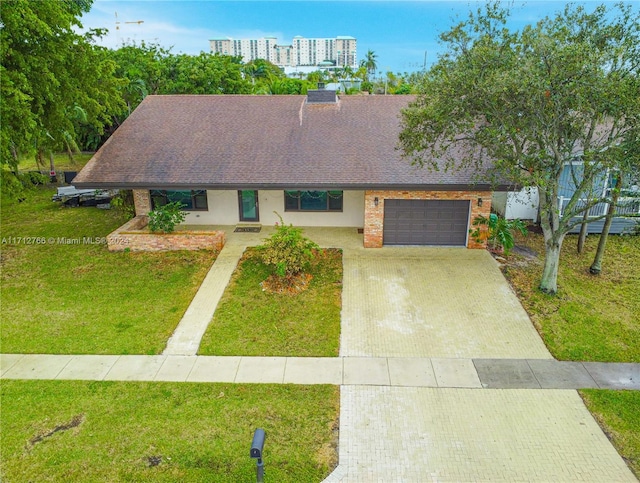 view of front of home featuring a front yard and a garage