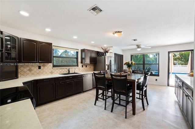 kitchen featuring ceiling fan, dark brown cabinets, sink, and appliances with stainless steel finishes