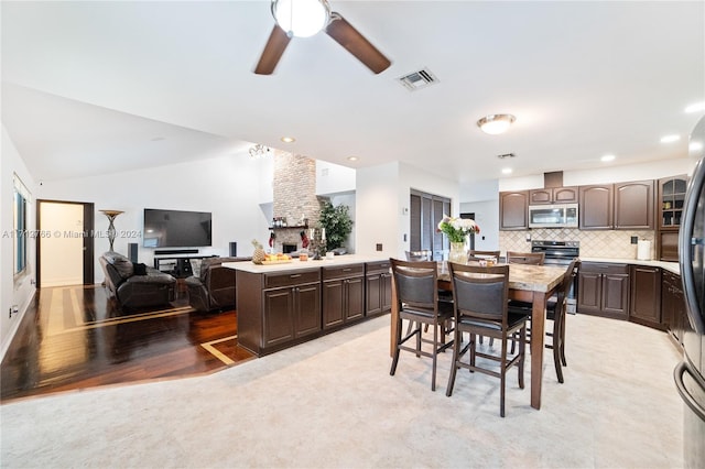 dining area featuring ceiling fan and vaulted ceiling