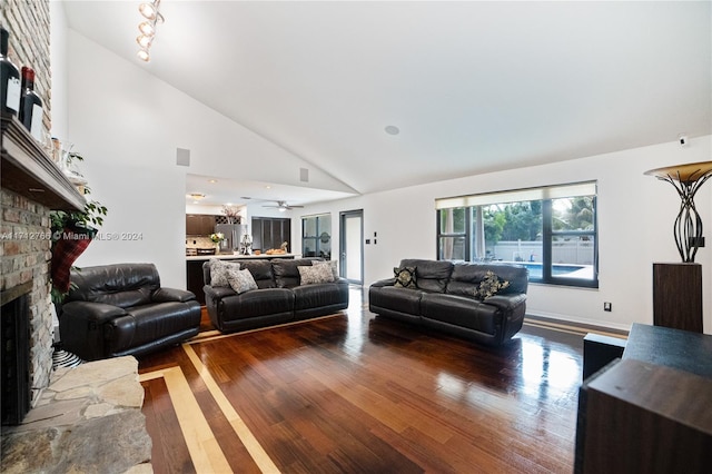 living room with a fireplace, hardwood / wood-style flooring, high vaulted ceiling, and ceiling fan