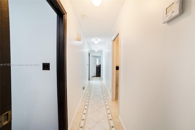 corridor with light tile patterned floors