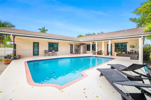 view of swimming pool featuring a patio and ceiling fan