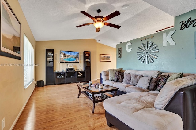 living room featuring hardwood / wood-style flooring, ceiling fan, a textured ceiling, and vaulted ceiling