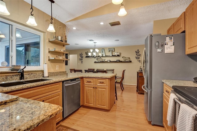 kitchen with kitchen peninsula, dishwasher, pendant lighting, and sink