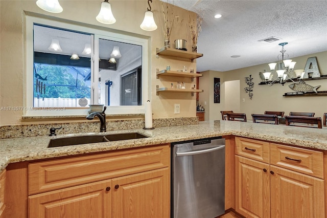 kitchen with an inviting chandelier, sink, stainless steel dishwasher, a textured ceiling, and decorative light fixtures