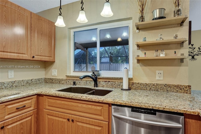 kitchen featuring dishwasher, decorative light fixtures, light stone countertops, and sink