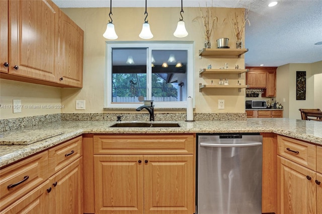 kitchen with decorative light fixtures, light stone counters, sink, and appliances with stainless steel finishes