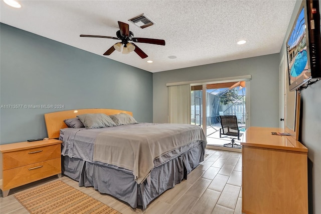 bedroom featuring access to exterior, ceiling fan, and a textured ceiling