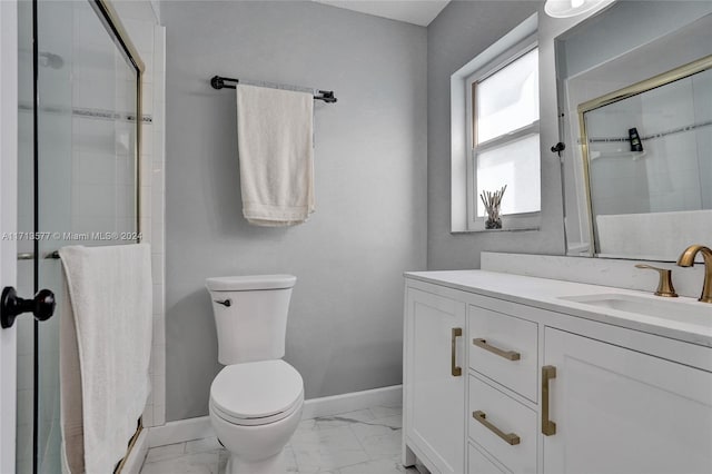 bathroom with vanity, toilet, and a shower with door