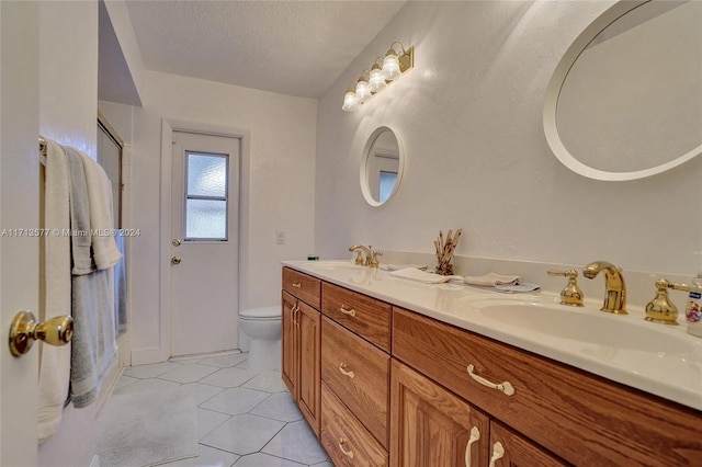 bathroom featuring tile patterned floors, walk in shower, vanity, a textured ceiling, and toilet