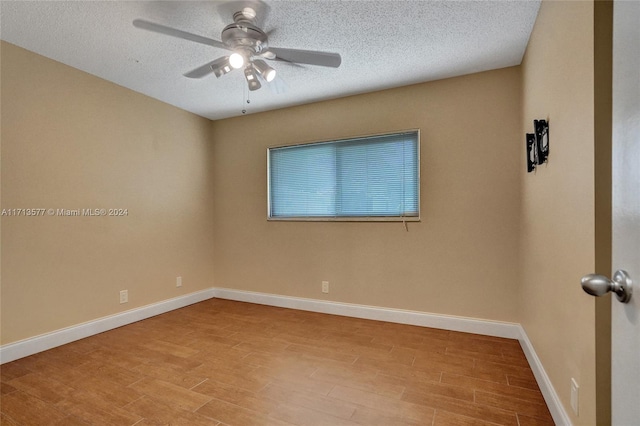 spare room featuring a textured ceiling, light hardwood / wood-style flooring, and ceiling fan