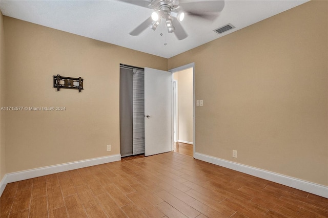 unfurnished bedroom with ceiling fan and light hardwood / wood-style flooring