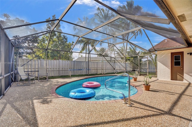 view of pool with a lanai and a patio area