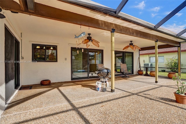 view of patio / terrace with glass enclosure and ceiling fan