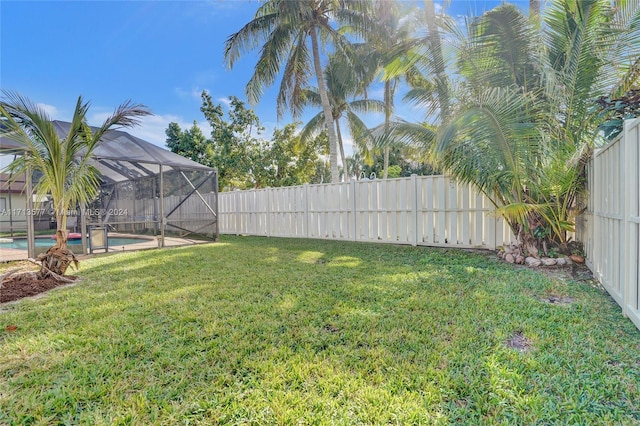 view of yard featuring a lanai and a fenced in pool