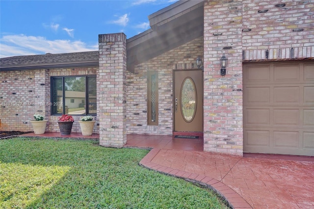 view of exterior entry with a yard