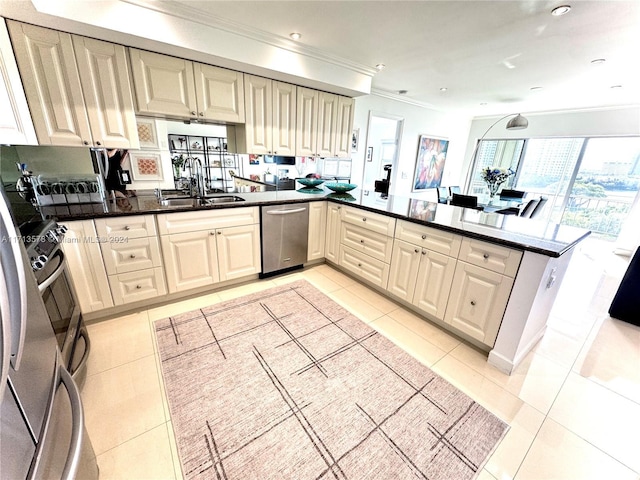 kitchen featuring kitchen peninsula, light tile patterned floors, stainless steel appliances, and sink