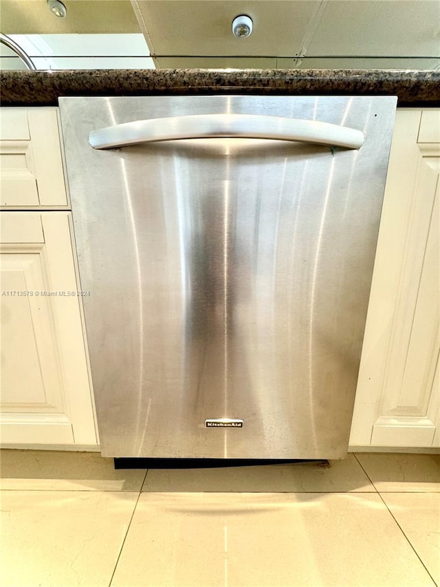 room details featuring dishwashing machine and white cabinetry