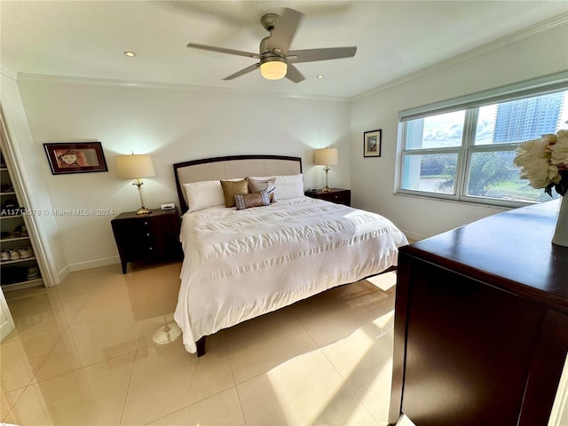 bedroom featuring ceiling fan, light tile patterned floors, and crown molding