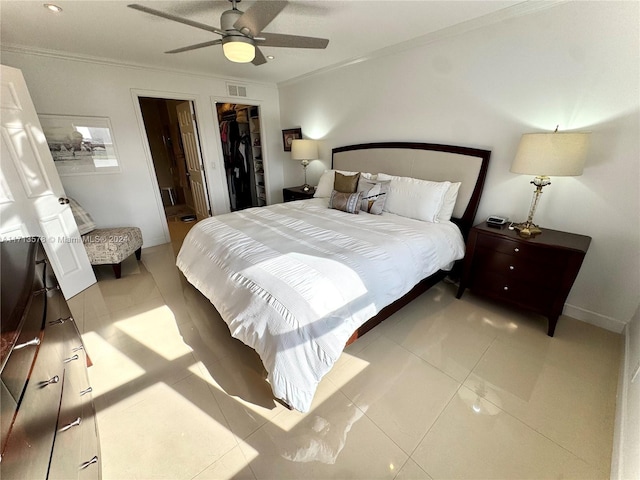 bedroom with ornamental molding, ceiling fan, a spacious closet, a closet, and light tile patterned flooring