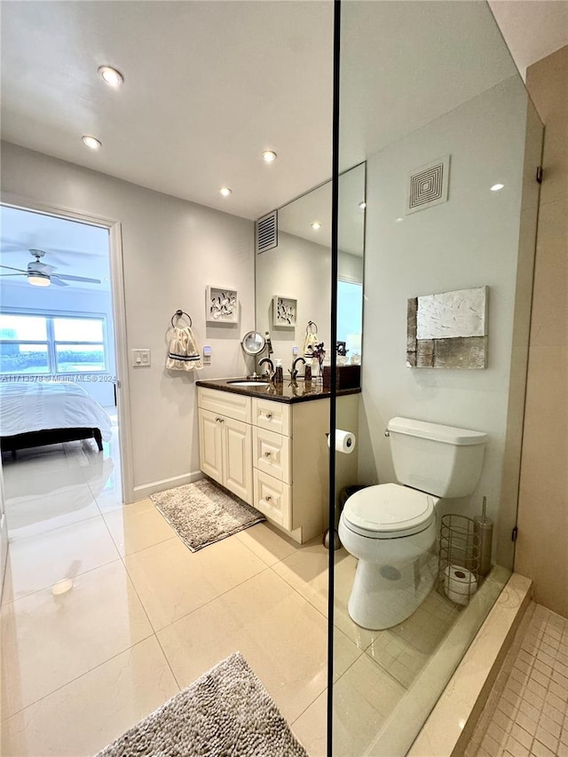 bathroom with tile patterned flooring, vanity, toilet, and ceiling fan