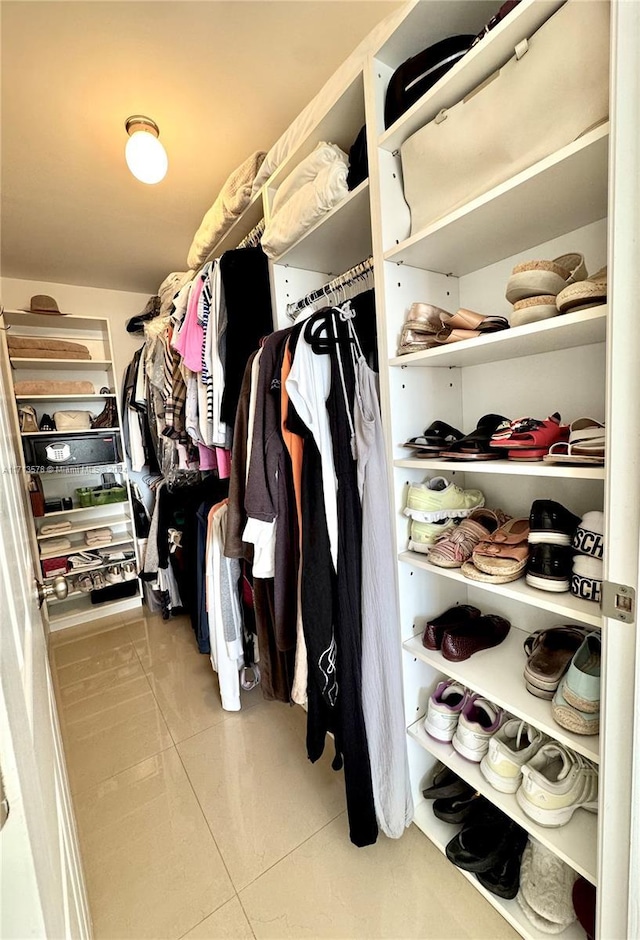 spacious closet featuring light tile patterned floors