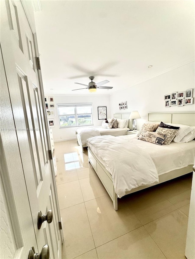 bedroom with ceiling fan and light tile patterned floors