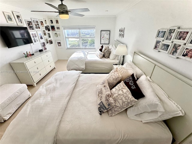 bedroom with ceiling fan and crown molding