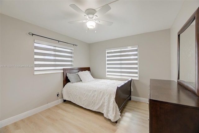 bedroom with ceiling fan and light wood-type flooring