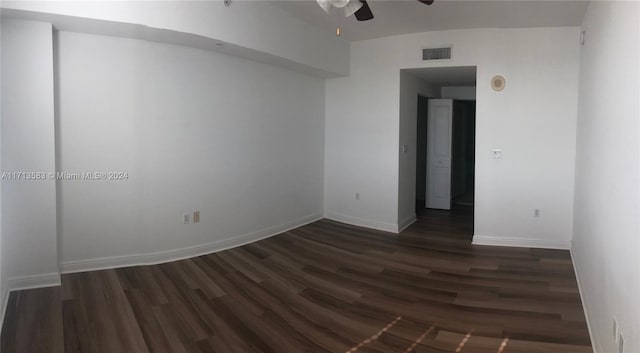 empty room with ceiling fan and dark hardwood / wood-style floors