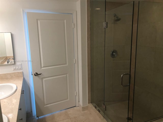 bathroom with tile patterned floors, vanity, and a shower with door