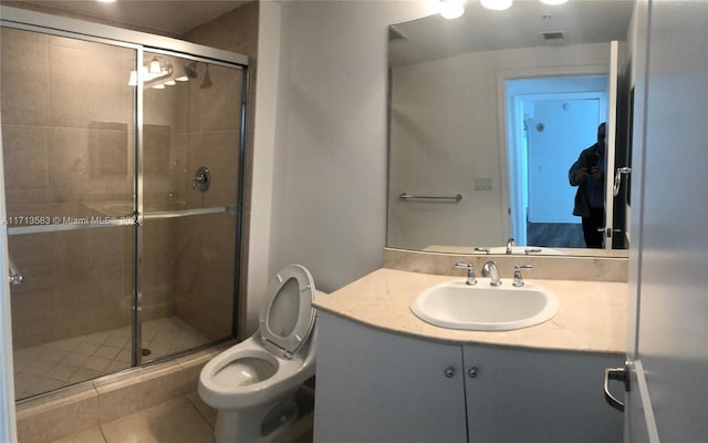 bathroom with tile patterned floors, vanity, walk in shower, and toilet