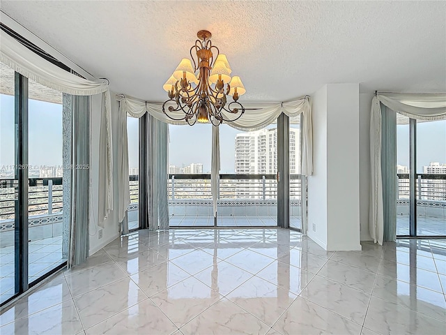 unfurnished dining area with expansive windows, a chandelier, and a textured ceiling