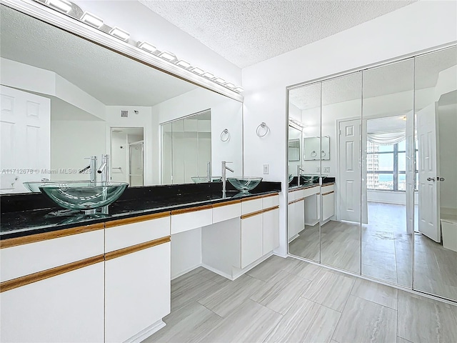 bathroom with vanity and a textured ceiling