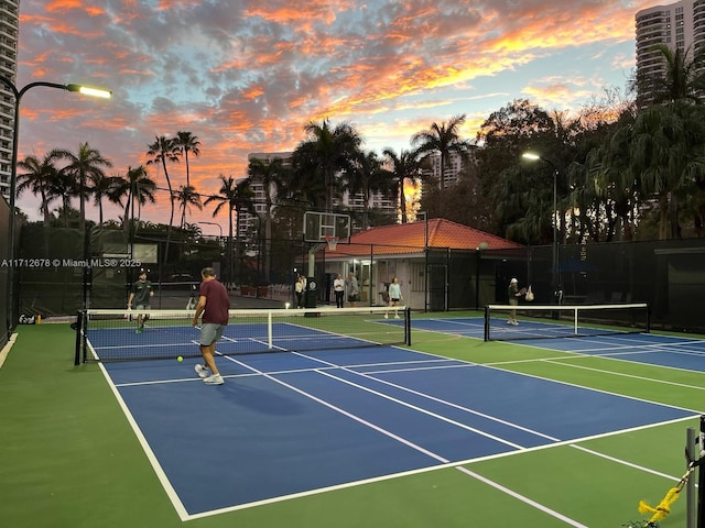 view of tennis court featuring basketball court