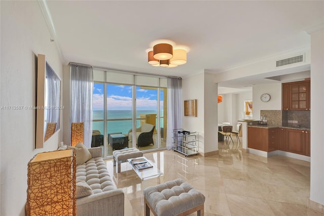 living room featuring a water view, crown molding, and floor to ceiling windows